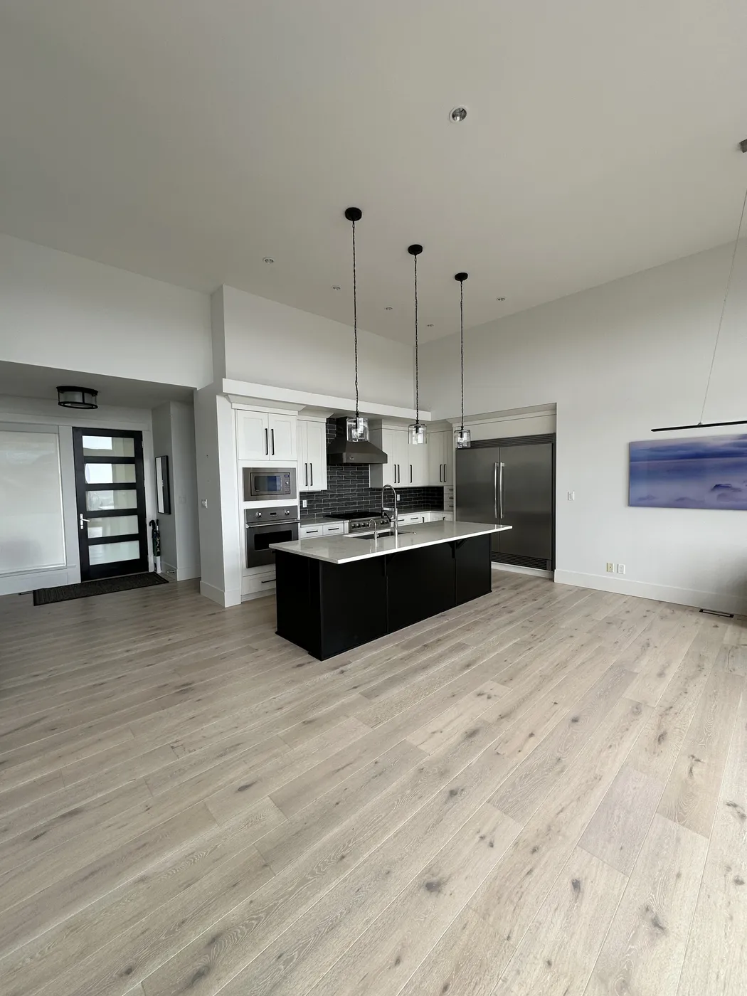 Modern kitchen renovation with island, cabinetry, and updated finishes