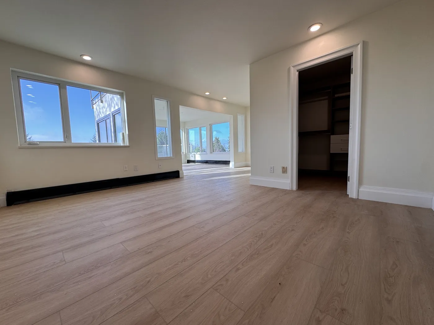 Open-concept interior renovation with new flooring and trim finishing